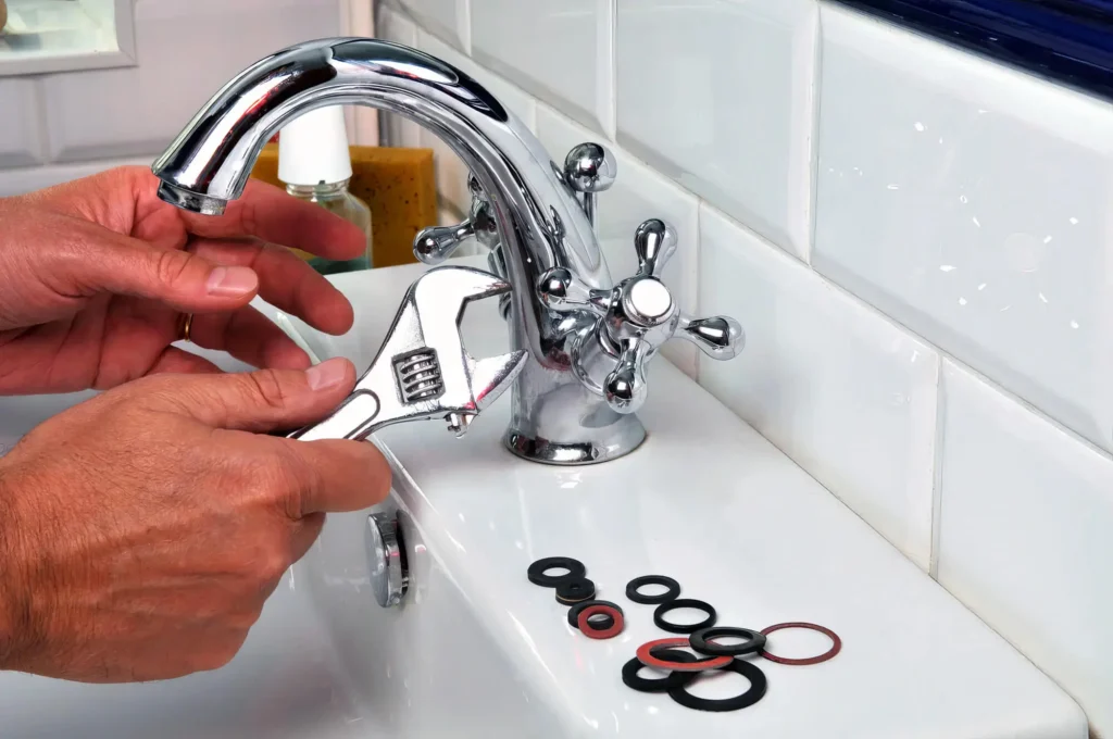 Plumber performing maintenance on a bathroom faucet in Lebanon