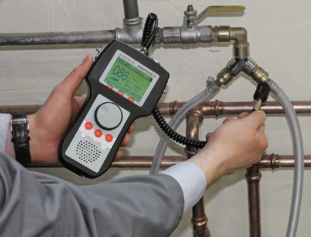 Plumber testing pipes with electronic leak detection equipment in Lebanon