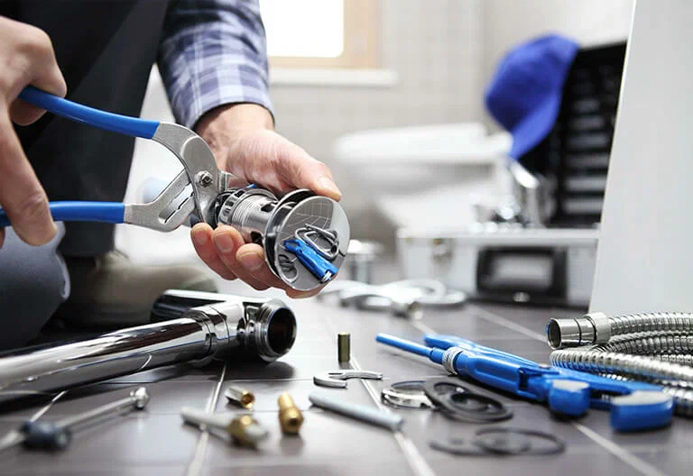 Technician repairing a plumbing fixture with professional tools in Lebanon