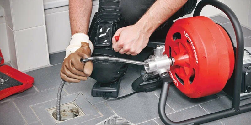 Plumber using a drain-cleaning machine in Lebanon