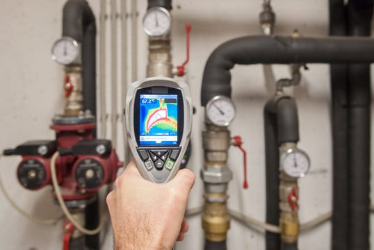 Plumber using a thermal imaging camera to inspect pipes in Lebanon