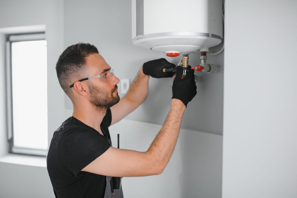 Technician performing water heater maintenance in Lebanon