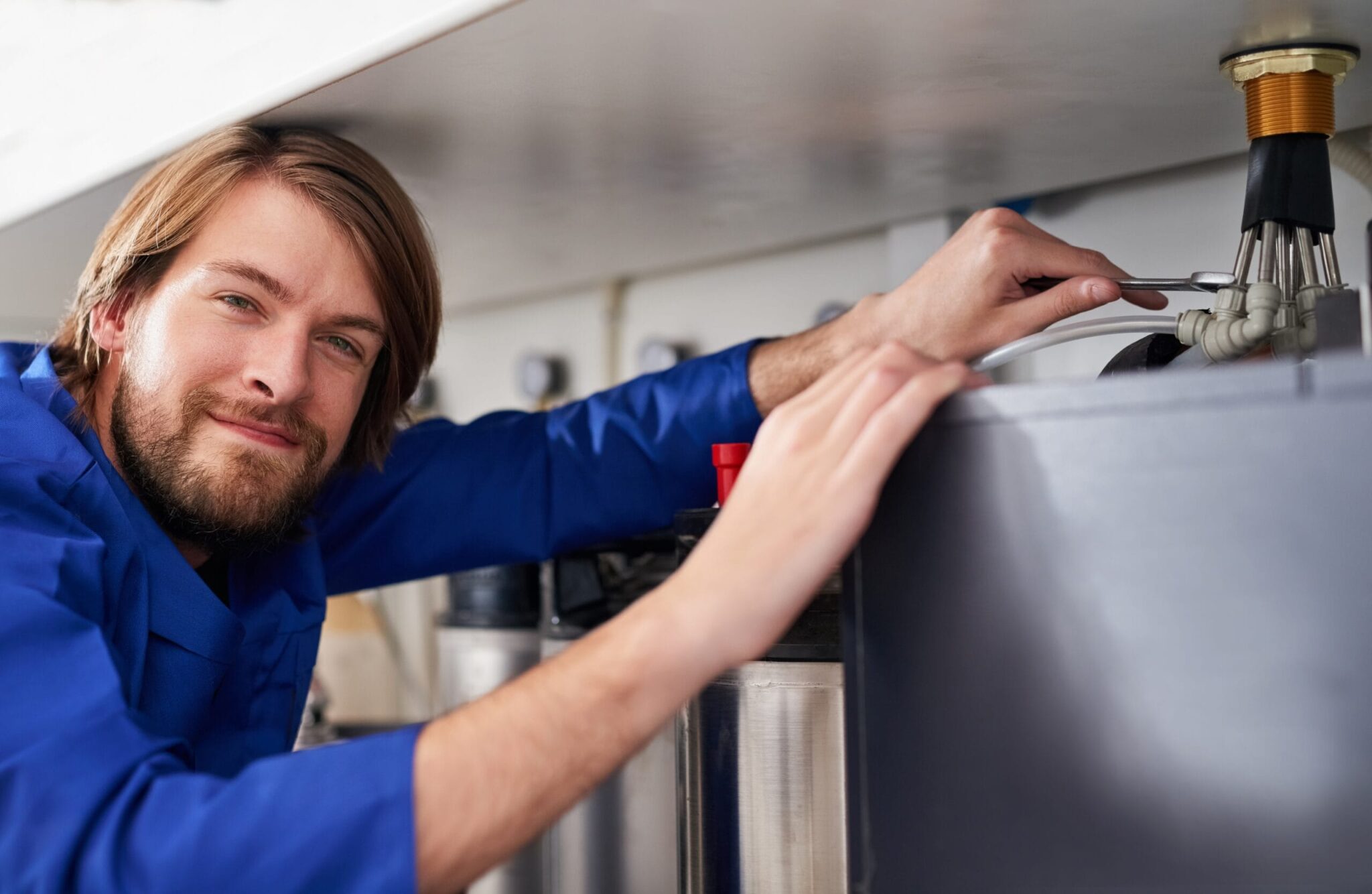 Technician servicing a residential water heater tank in Lebanon