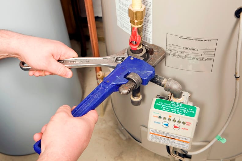 Plumber repairing a water heater valve in Lebanon